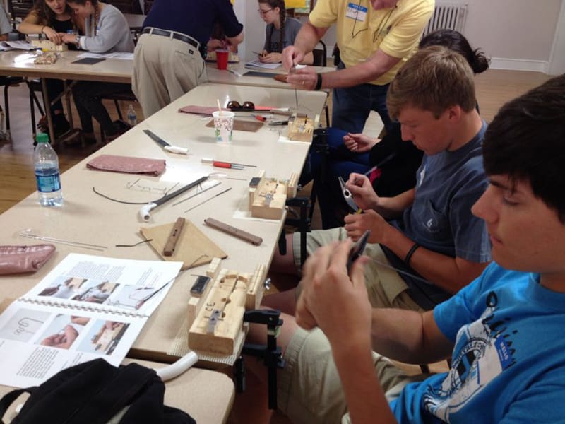 Students crafting jewelry in a workshop.