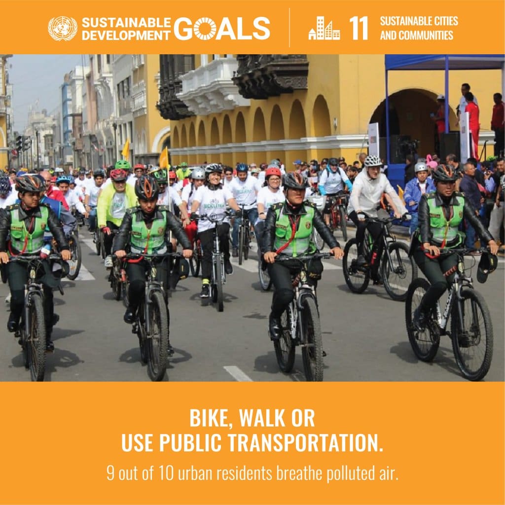 A group of people riding bikes down the street.