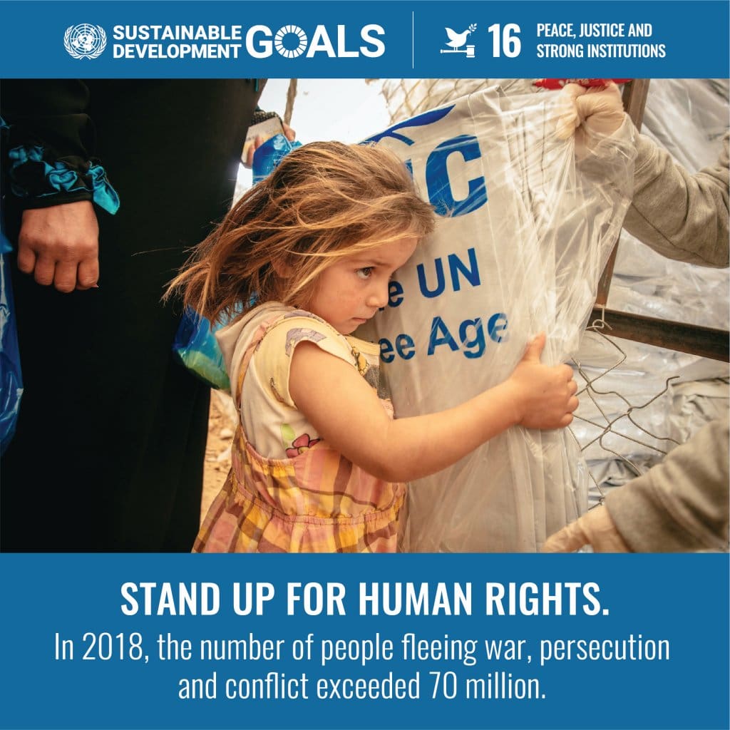 A child holding onto a sign that says stand up for human rights.