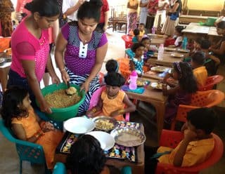 A group of people sitting around eating food.