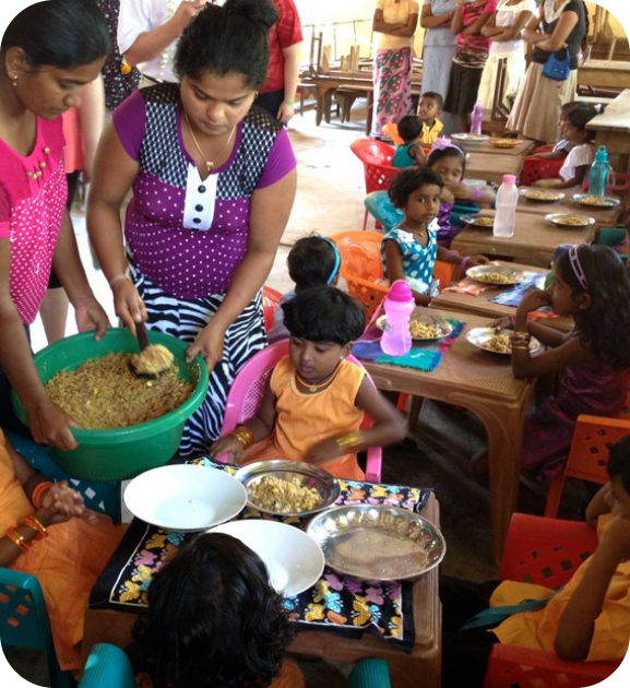 Children eating food at a community meal.