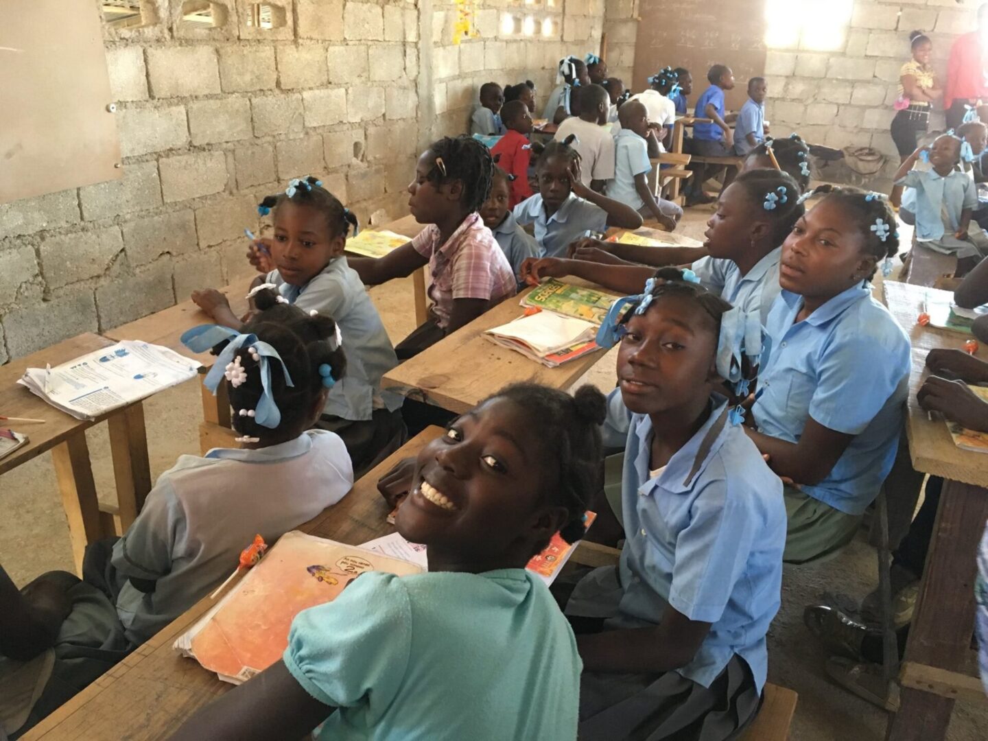 A group of children sitting at desks in a classroom.