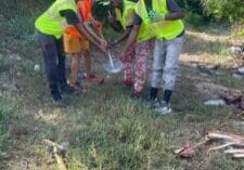 Young people cleaning up outdoors.