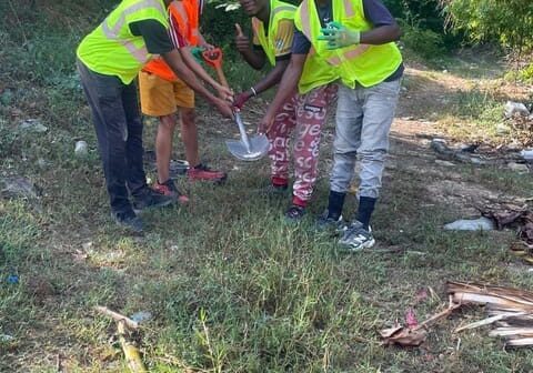 Young people cleaning up outdoors.
